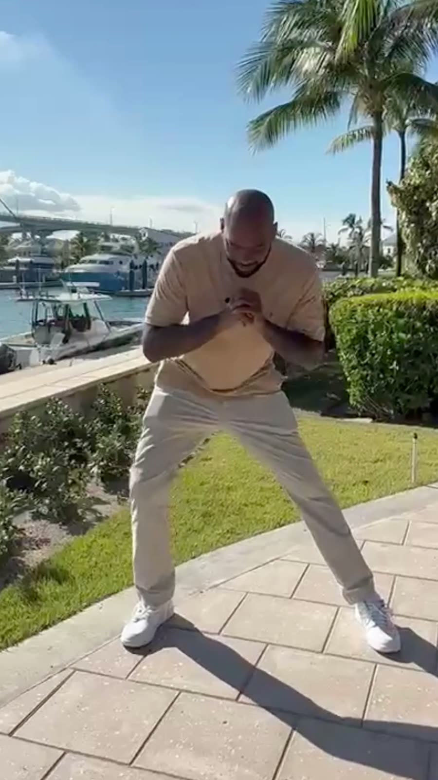 Athlete demonstrating a movement drill beside the Paradise Island marina